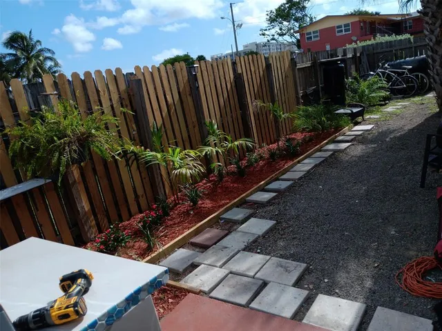 a view of a backyard with potted plants
