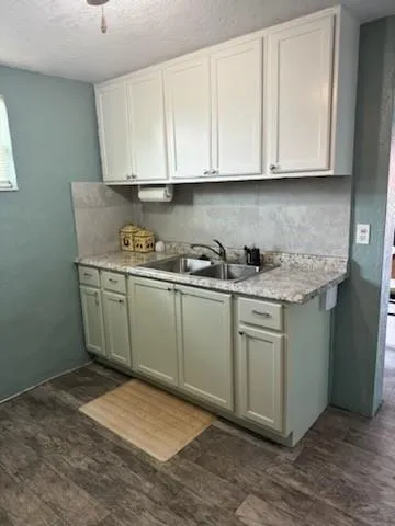 a kitchen with stainless steel appliances granite countertop a sink a stove and cabinets