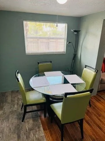a view of a dining room with furniture and window