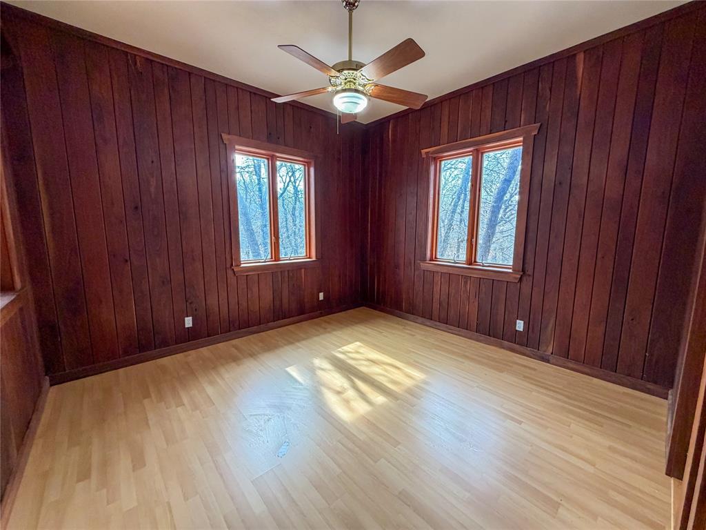 322 Wild Wood Drive Decatur, TX 76234 - Photo 16 of 39 an empty room with windows chandelier fan and windows