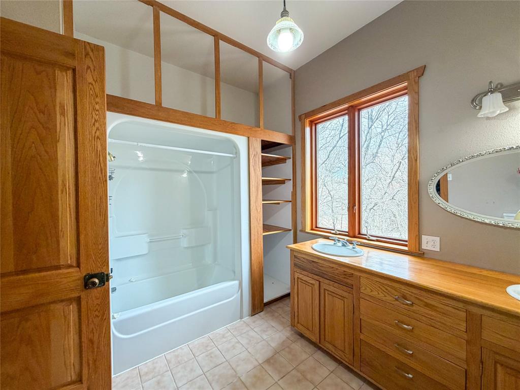 322 Wild Wood Drive Decatur, TX 76234 - Photo 21 of 39 a bathroom with a granite countertop sink mirror bathtub and shower
