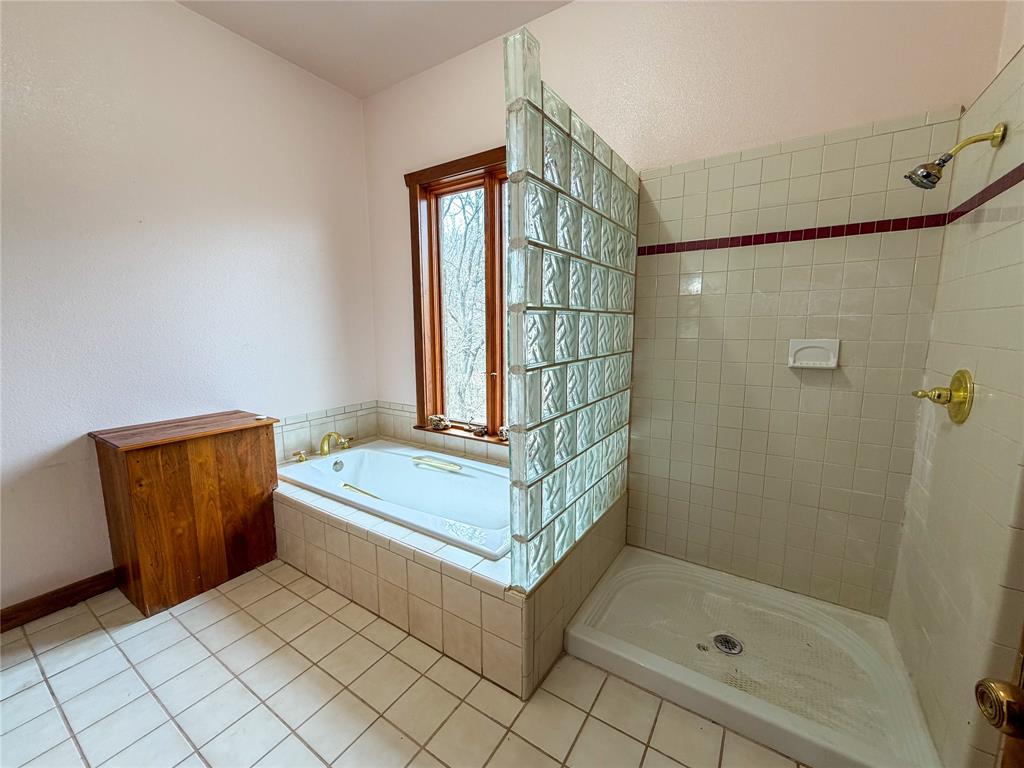 322 Wild Wood Drive Decatur, TX 76234 - Photo 27 of 39 a bathroom with a tub and shower