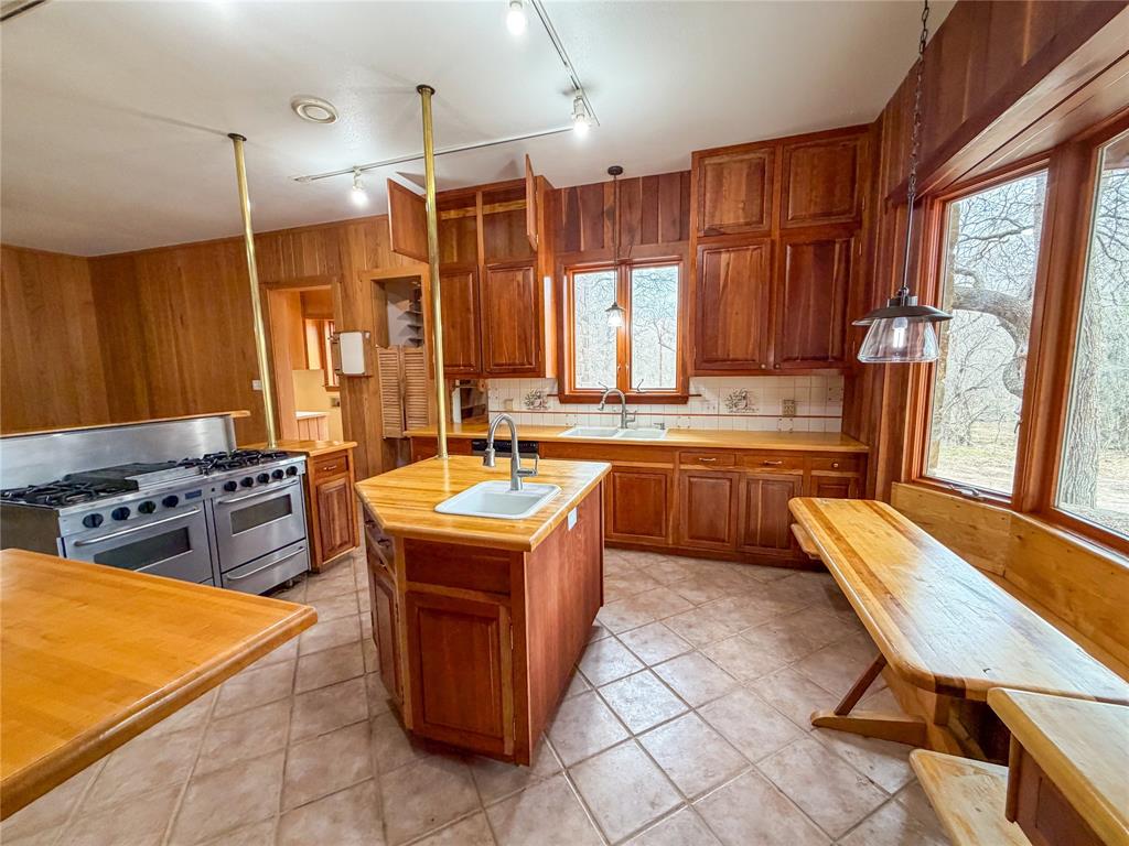 322 Wild Wood Drive Decatur, TX 76234 - Photo 3 of 39 a kitchen with a stove sink and cabinets