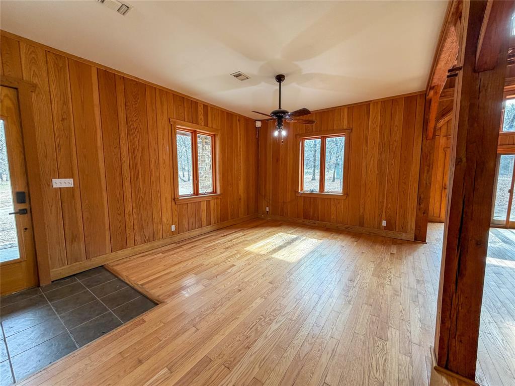 322 Wild Wood Drive Decatur, TX 76234 - Photo 6 of 39 an empty room with wooden floor and windows