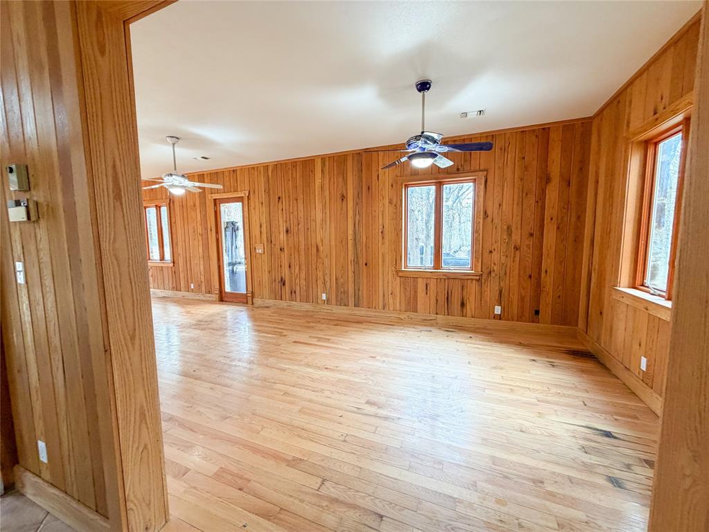 322 Wild Wood Drive Decatur, TX 76234 - Photo 9 of 39 a view of a room with wooden floor and windows