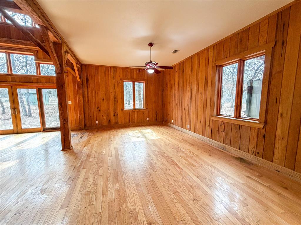 322 Wild Wood Drive Decatur, TX 76234 - Photo 10 of 39 a view of an empty room with wooden floor and a window