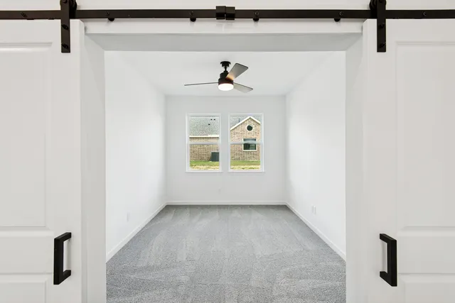 a view of room with a ceiling fan