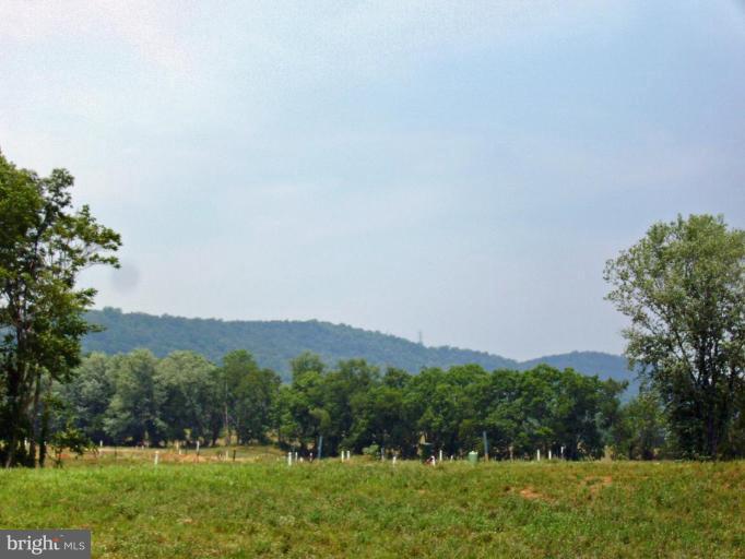 4004 Pennyfields Lcks Point Point of Rocks, MD 21777 - Photo 2 of 2 a view of a grassy field with trees in the background