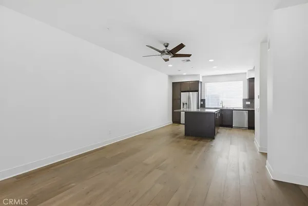 a kitchen with stainless steel appliances a refrigerator sink and cabinets