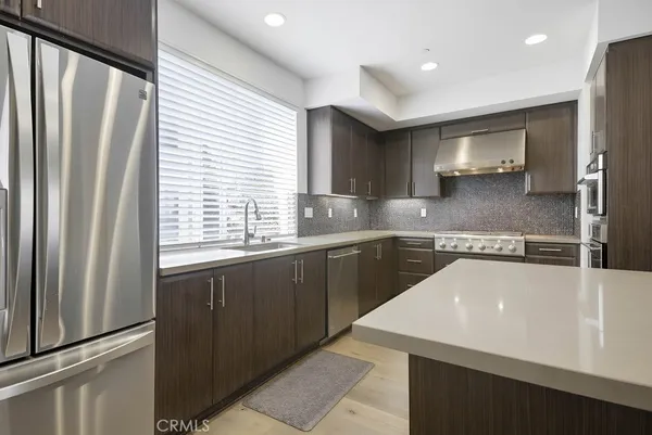 a kitchen with granite countertop cabinets and steel stainless steel appliances