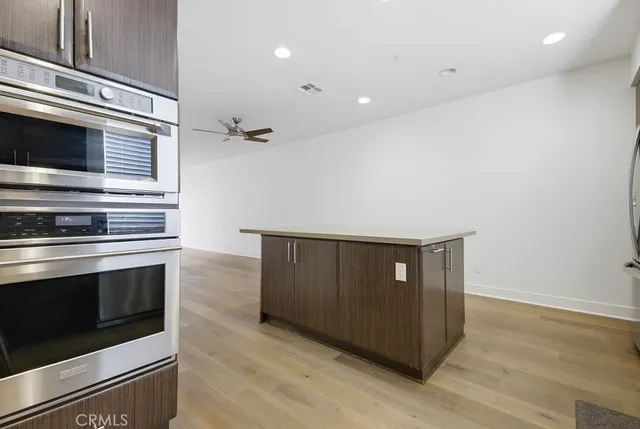 a view of an empty room and a ceiling fan