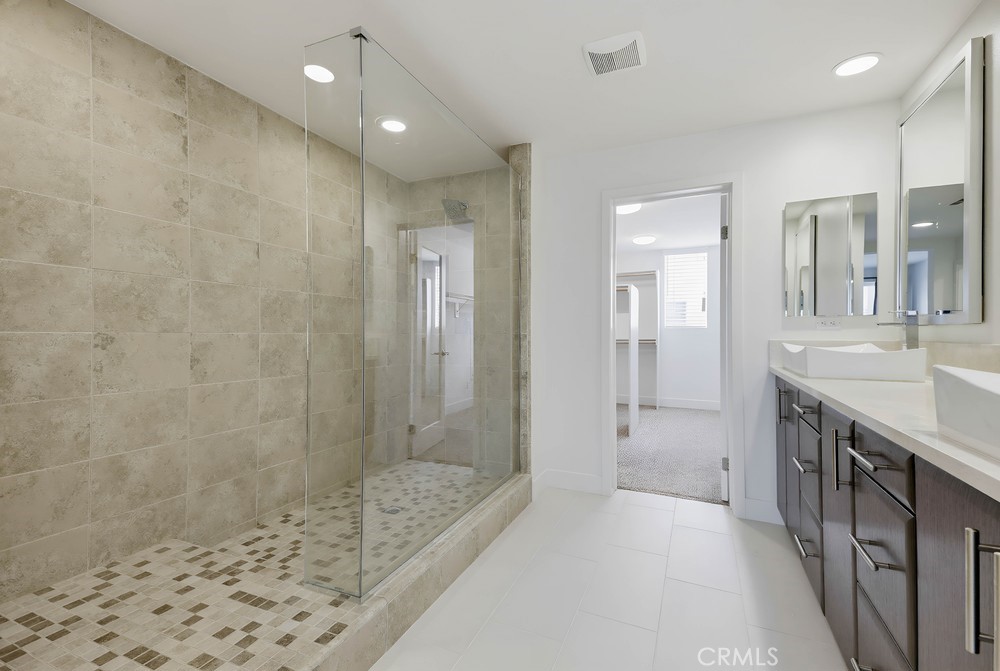 75 Lennox Irvine, CA 92612 - Photo 29 of 71 a bathroom with a granite countertop sink a shower and a mirror