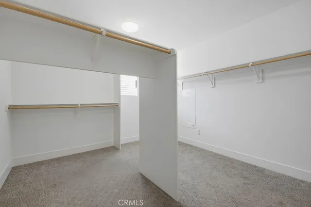 an empty room with ceiling fan and window