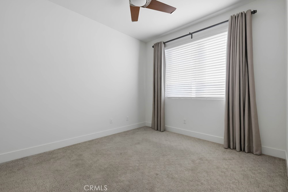 75 Lennox Irvine, CA 92612 - Photo 51 of 73 an empty room with ceiling fan and window