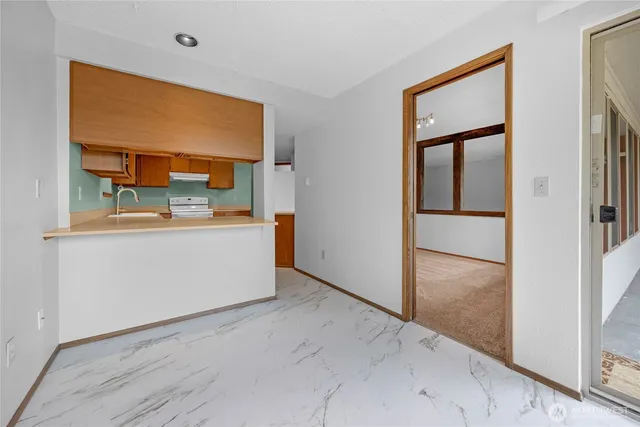 a view of a room with a sink and a mirror