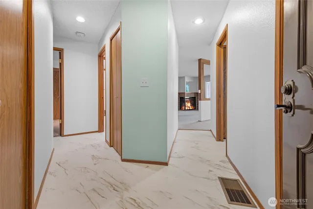a view of a hallway with living room and dining room view