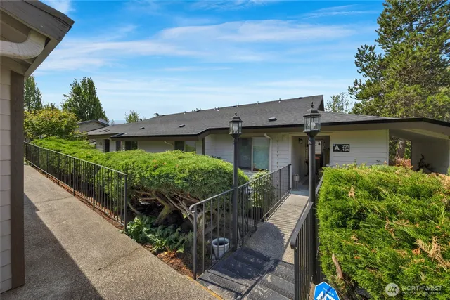 a view of a house with wooden fence