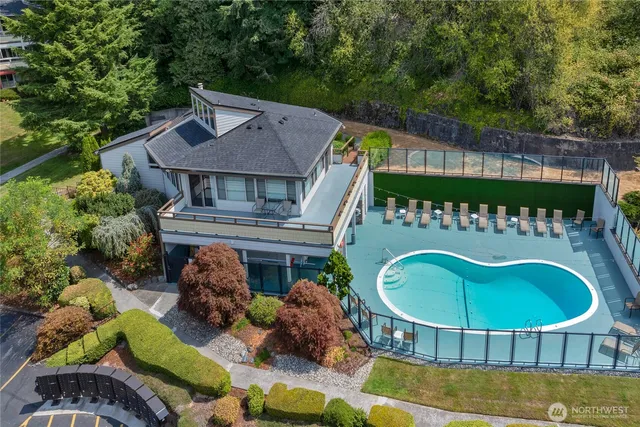 a view of a chairs and table in the backyard
