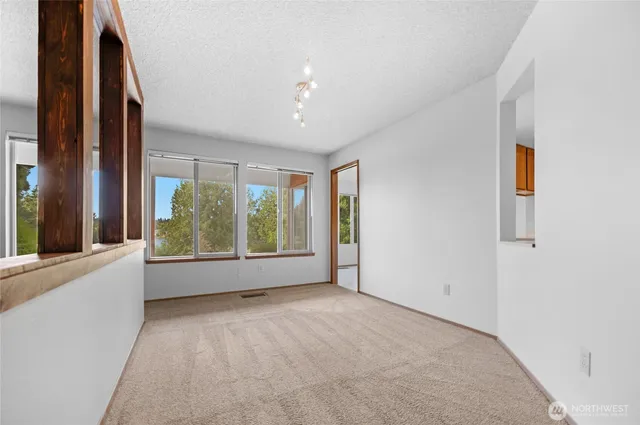 an empty room with windows and yard