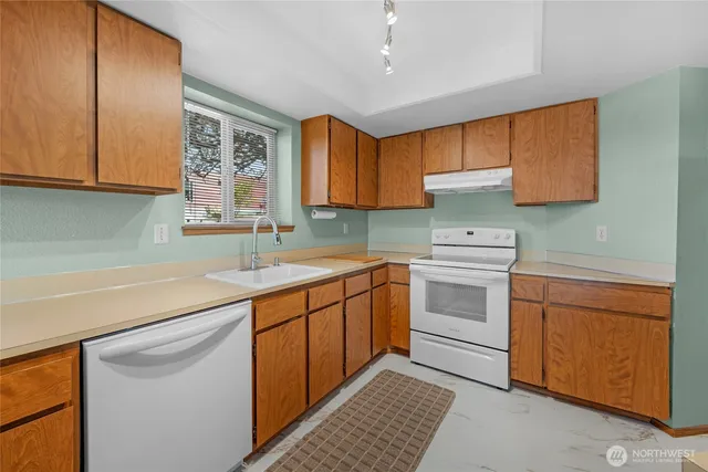 a kitchen with a sink stove and cabinets