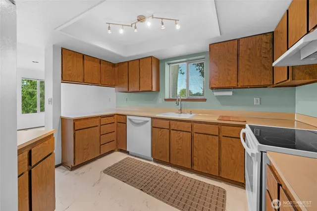 a kitchen with a sink cabinets and window