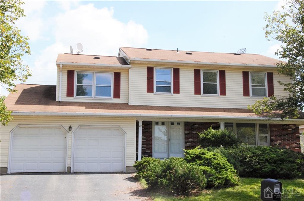 27 Sinclair Road Edison, NJ 08820 - Photo 1 of 15 a view of a white building with large windows and a yard with plants