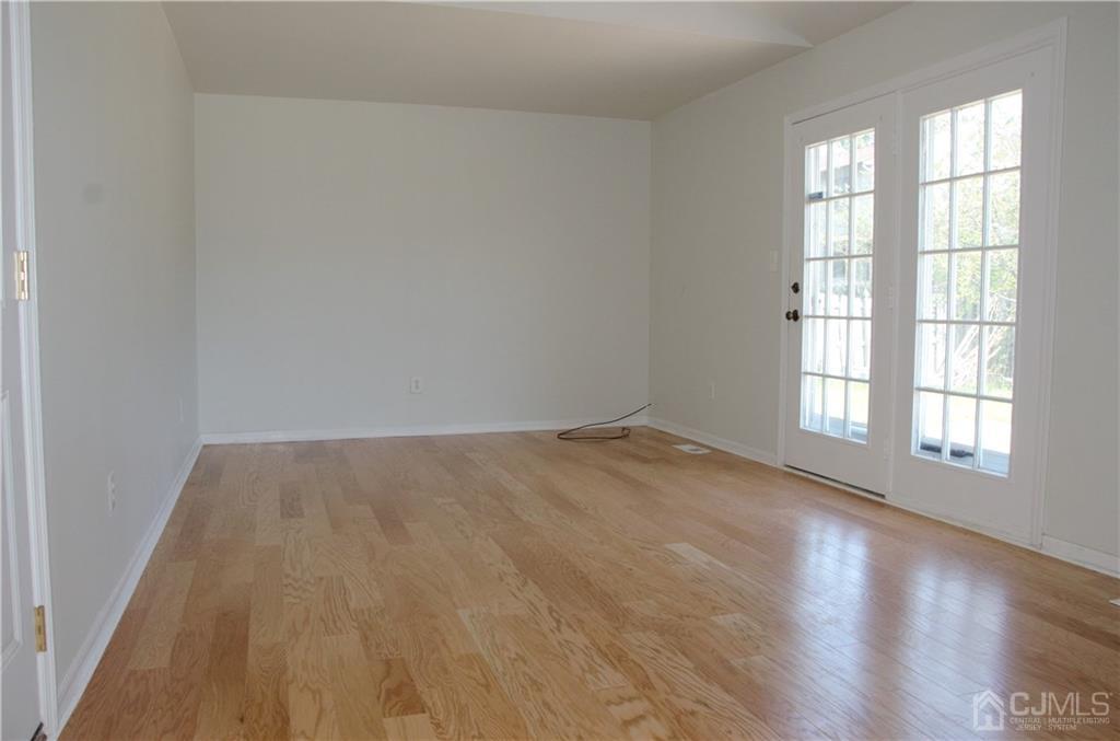 27 Sinclair Road Edison, NJ 08820 - Photo 14 of 15 an empty room with wooden floor and windows