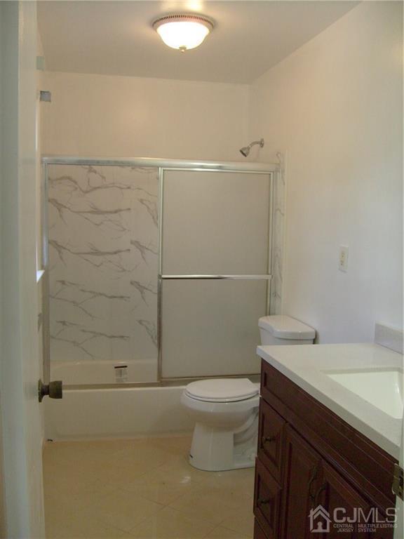 27 Sinclair Road Edison, NJ 08820 - Photo 5 of 15 a bathroom with a sink a toilet and shower