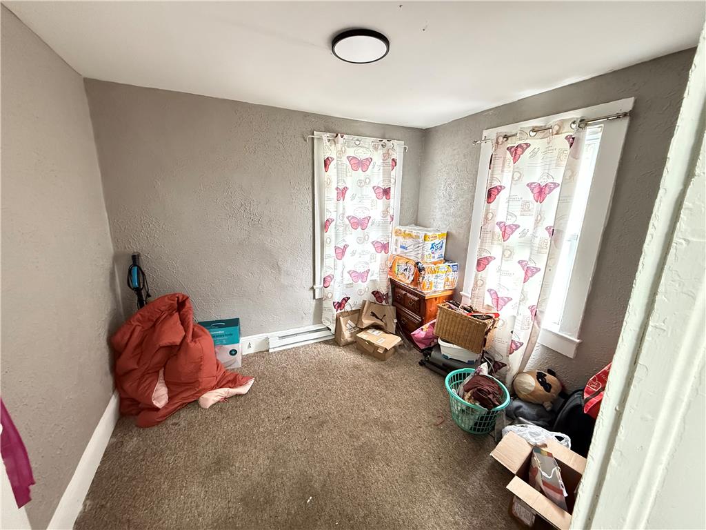 700 Philo Street Scranton, PA 18508 - Photo 14 of 19 A cozy bedroom features soft carpet and ample window light.