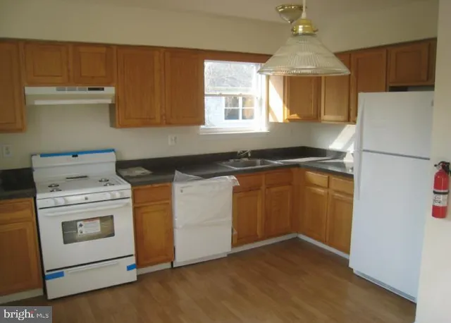 a kitchen with a stove sink and refrigerator
