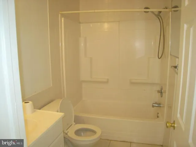 a bathroom with a shower a toilet and a shower