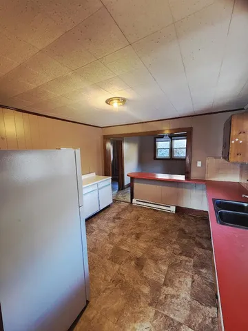 a kitchen with refrigerator and microwave
