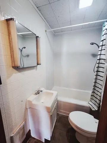 a bathroom with a sink a toilet and bathtub