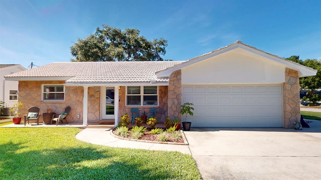 a view of a house with sitting area and garden