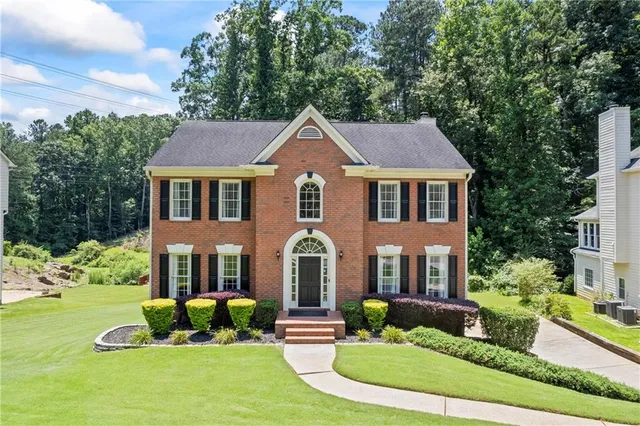 a front view of a house with a yard