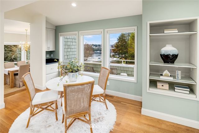 a dining room with furniture and wooden floor