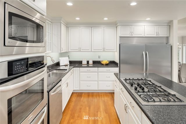 a kitchen with sink refrigerator and stove
