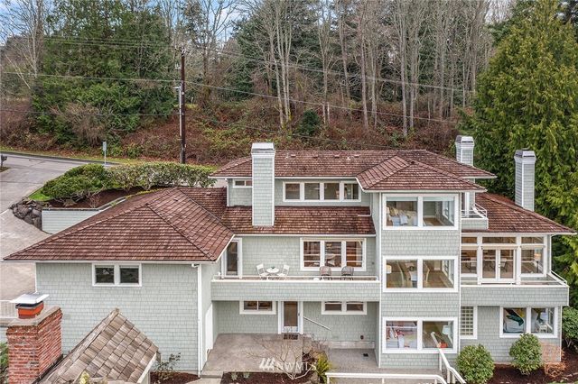 a aerial view of a brick house next to a yard