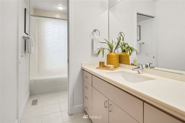a utility room with cabinets washer and dryer