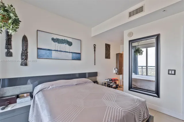 a bedroom with bed and window