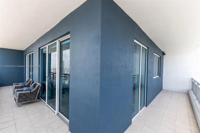 a view of a multi story residential apartment building with a yard