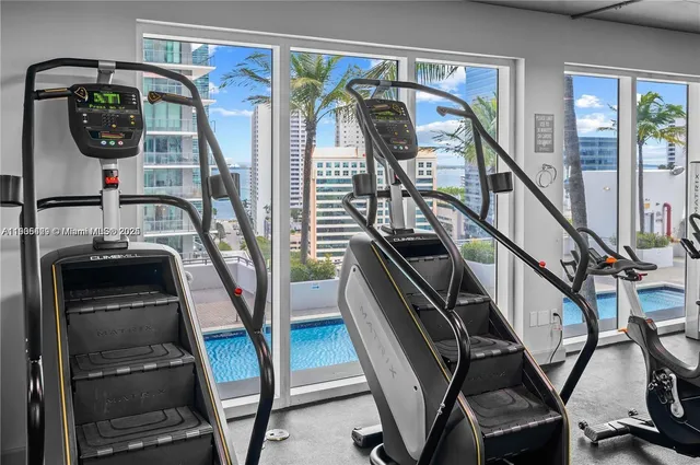a dining room with furniture and potted plants