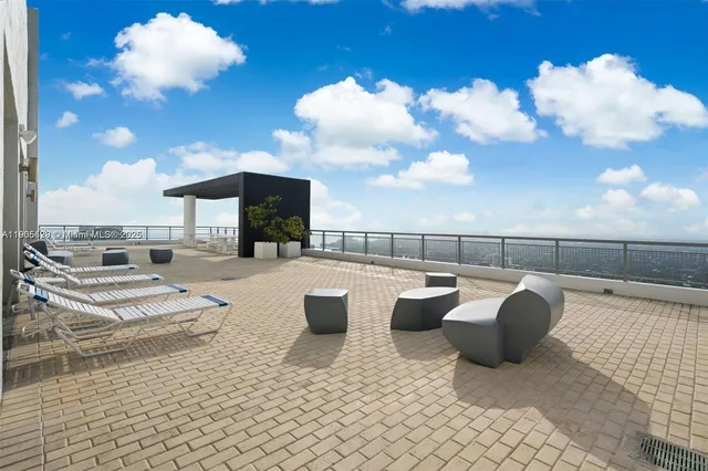 a view of a chairs and table in a balcony