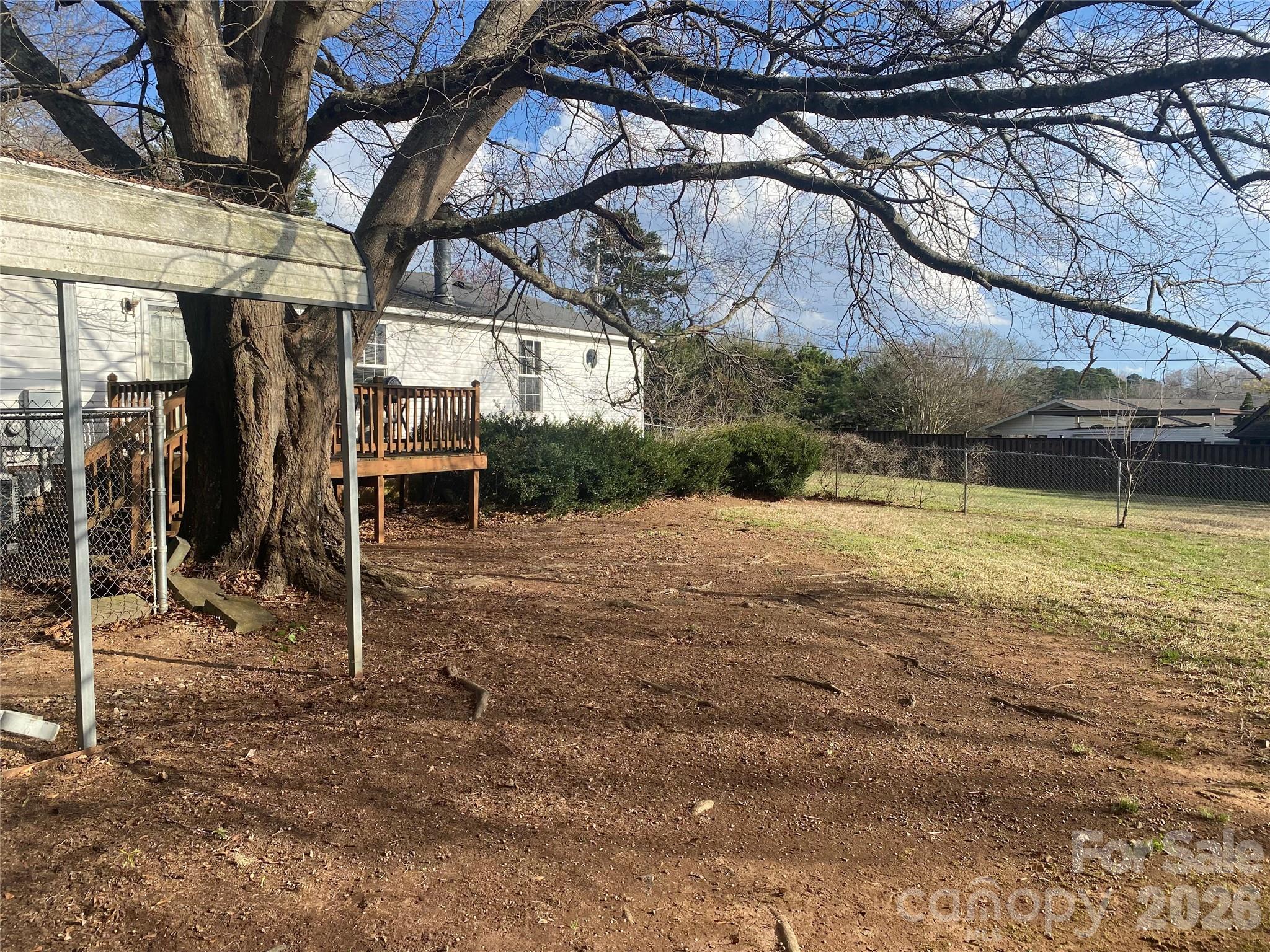 1011 Kiser Dairy Road Dallas, NC 28034 - Photo 15 of 17 a view of a backyard with table and chairs under an umbrella