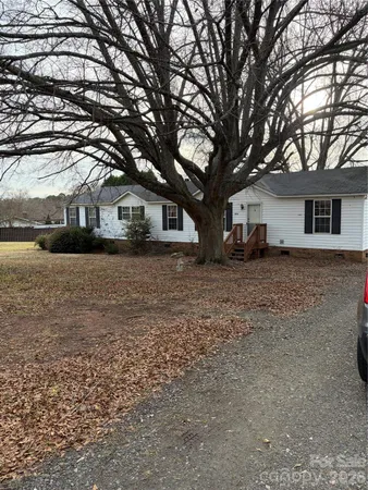 a front view of house with yard and trees