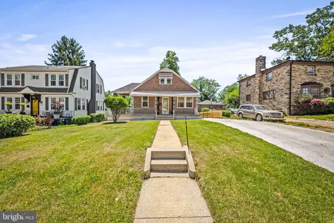 a front view of a house with swimming pool having outdoor seating