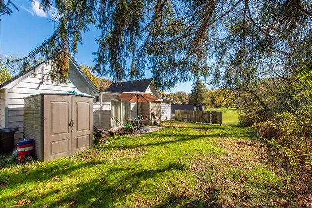 a view of a house with backyard and sitting area