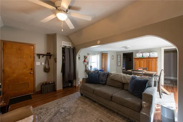 a living room with furniture and a chandelier