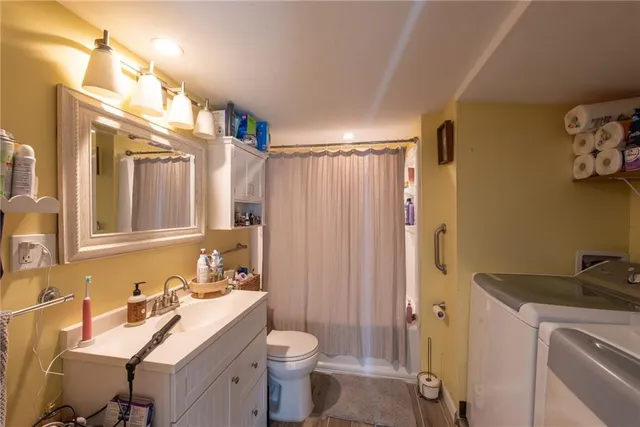 a bathroom with a sink toilet and shower