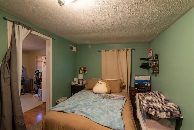 a bedroom with a bed and a tv